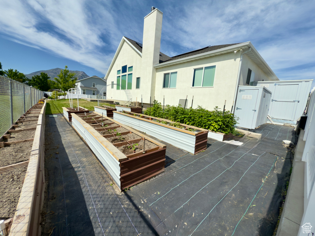 View of property\\\\\\\'s community with a garden, a gate, and a mountain view