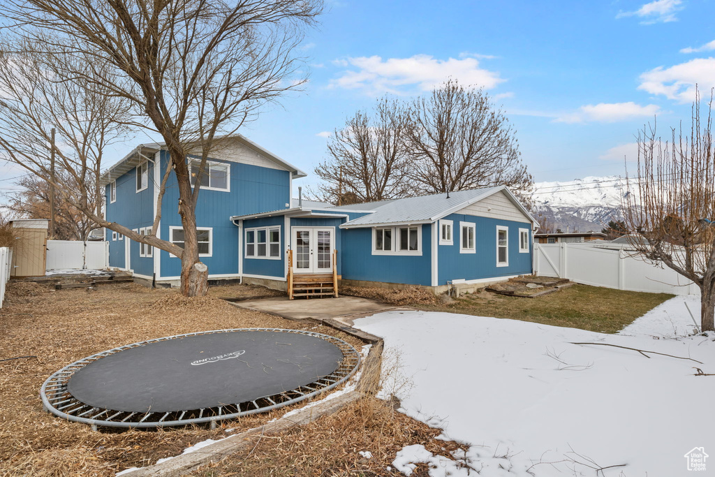 Rear view of house with a trampoline