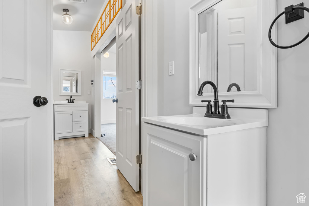 Bathroom with vanity and wood-type flooring