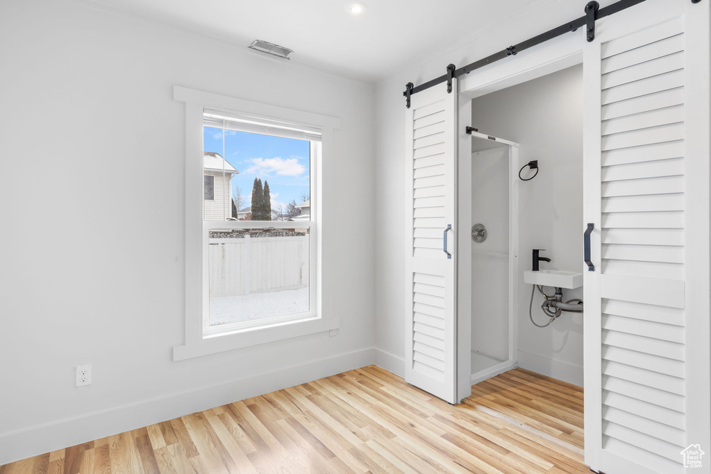 Interior space featuring a barn door and light hardwood / wood-style floors