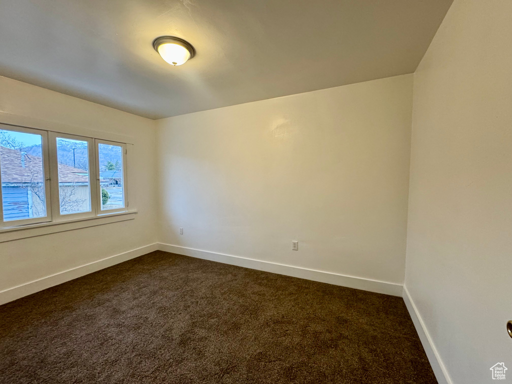 Empty room with dark carpet