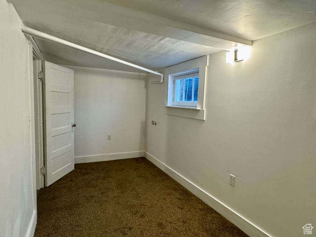 Basement with dark colored carpet
