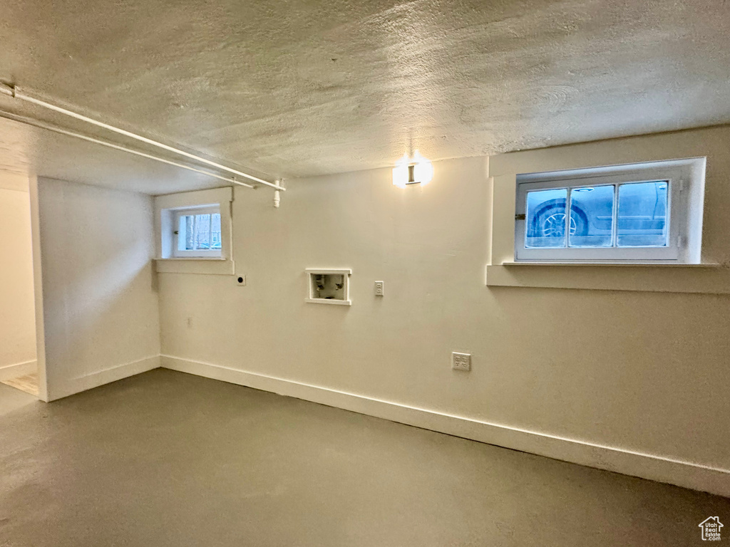 Basement featuring a textured ceiling