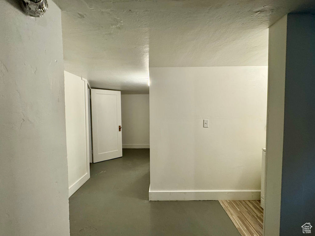 Interior space featuring concrete flooring and a textured ceiling