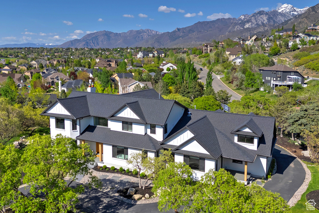 Birds eye view of property with a mountain view and a residential view