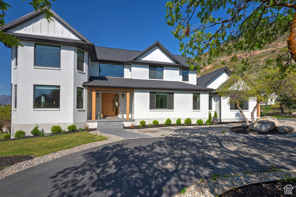 Modern inspired farmhouse with board and batten siding and brick siding