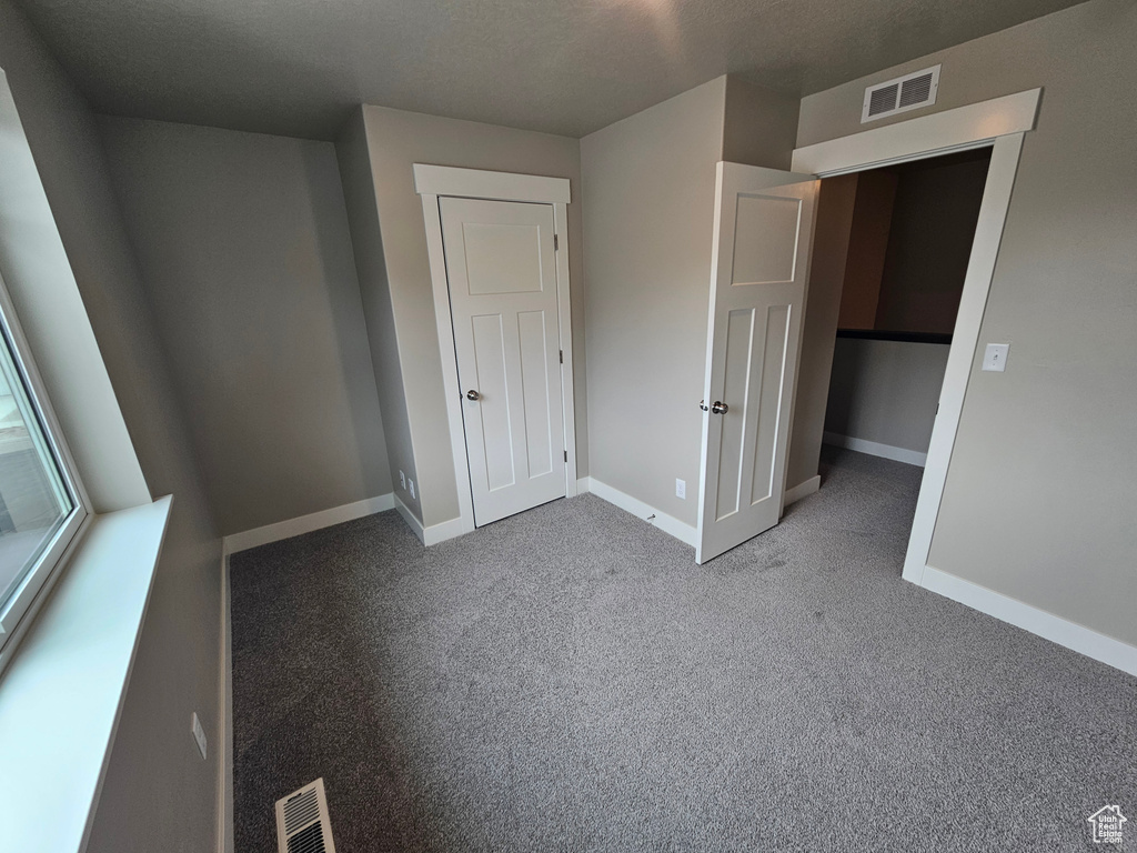 Unfurnished bedroom with carpet