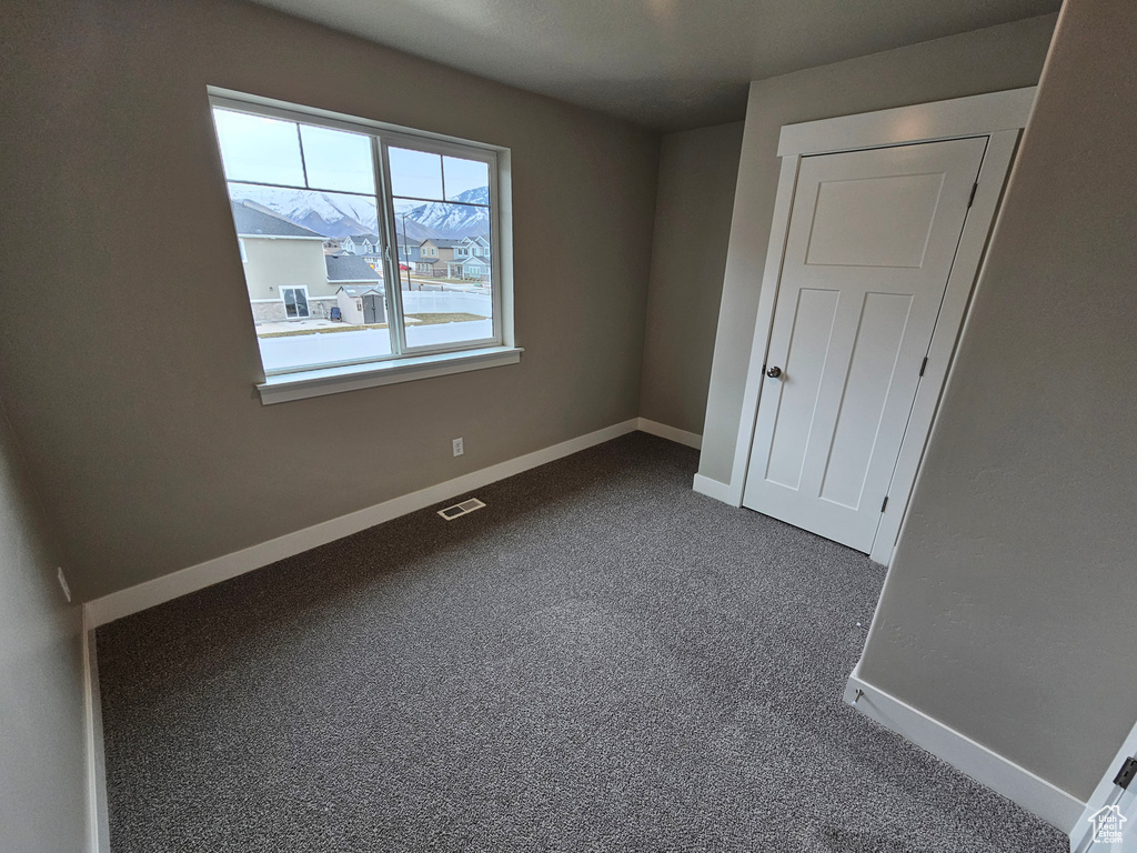 Unfurnished bedroom featuring carpet flooring