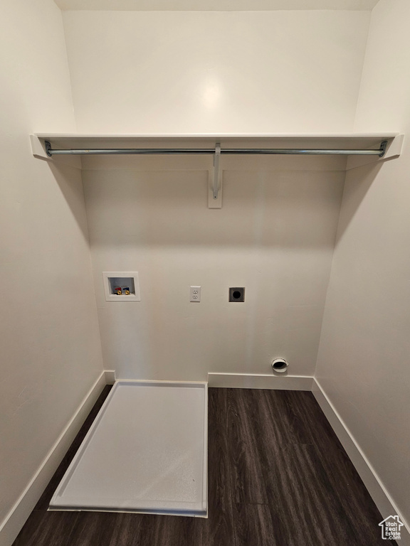 Washroom with dark hardwood / wood-style flooring, hookup for a washing machine, and hookup for an electric dryer