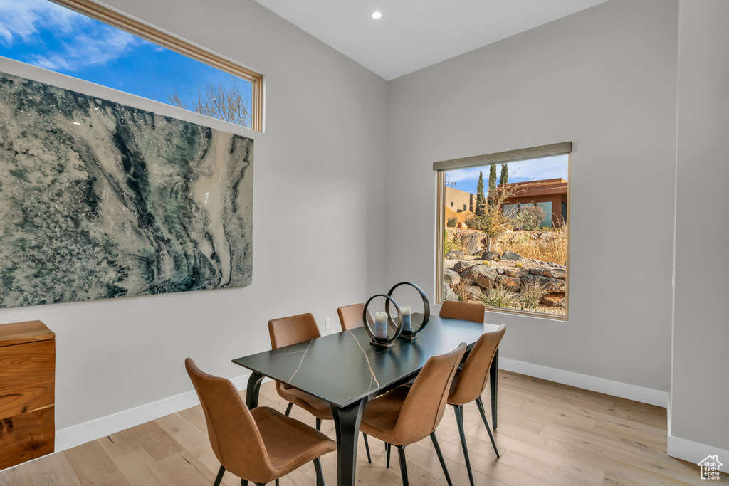 Dining space with light hardwood / wood-style flooring