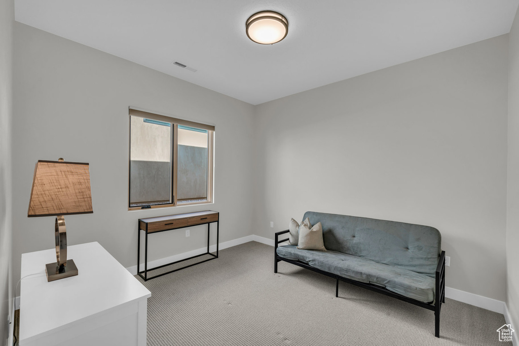 Sitting room featuring light colored carpet