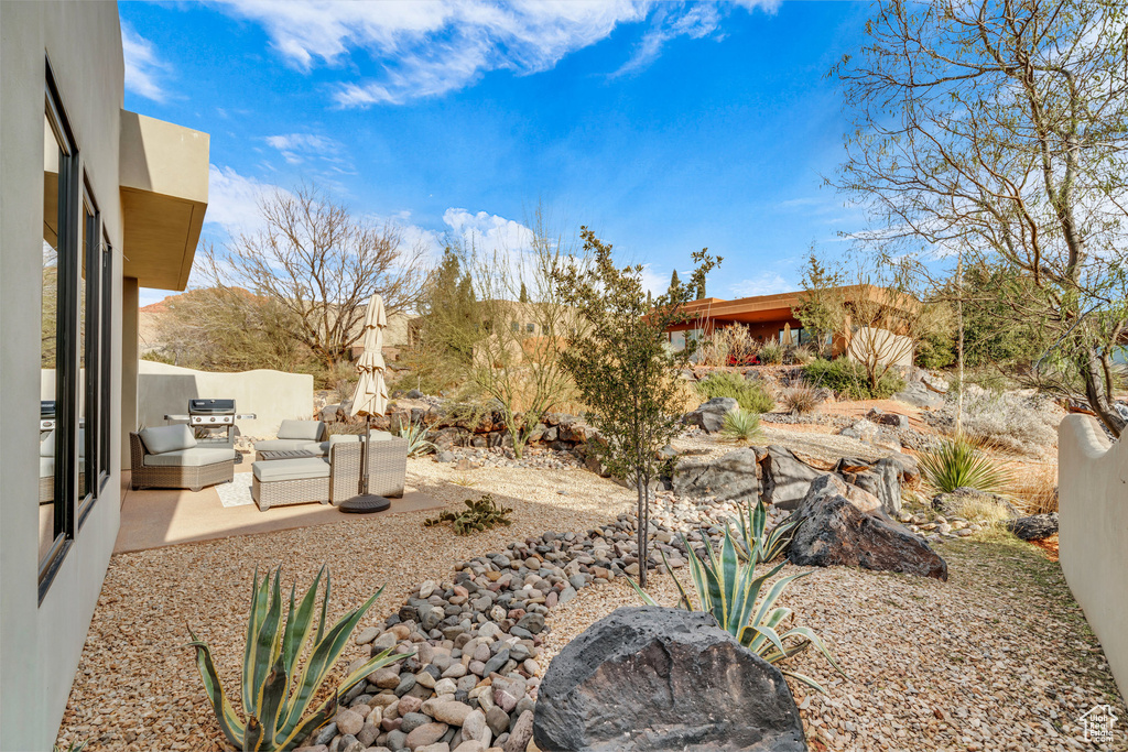 View of yard with outdoor lounge area and a patio area