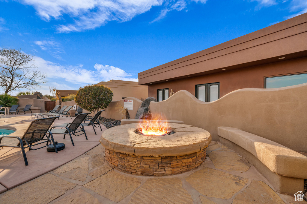 View of patio with a fire pit