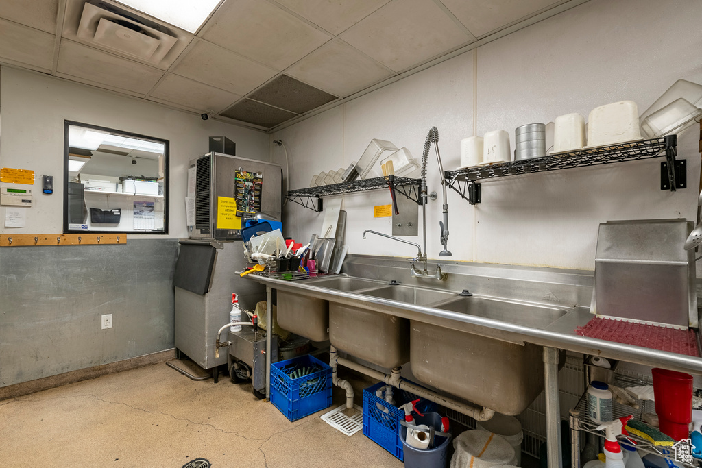 Interior space with a paneled ceiling and stainless steel counters