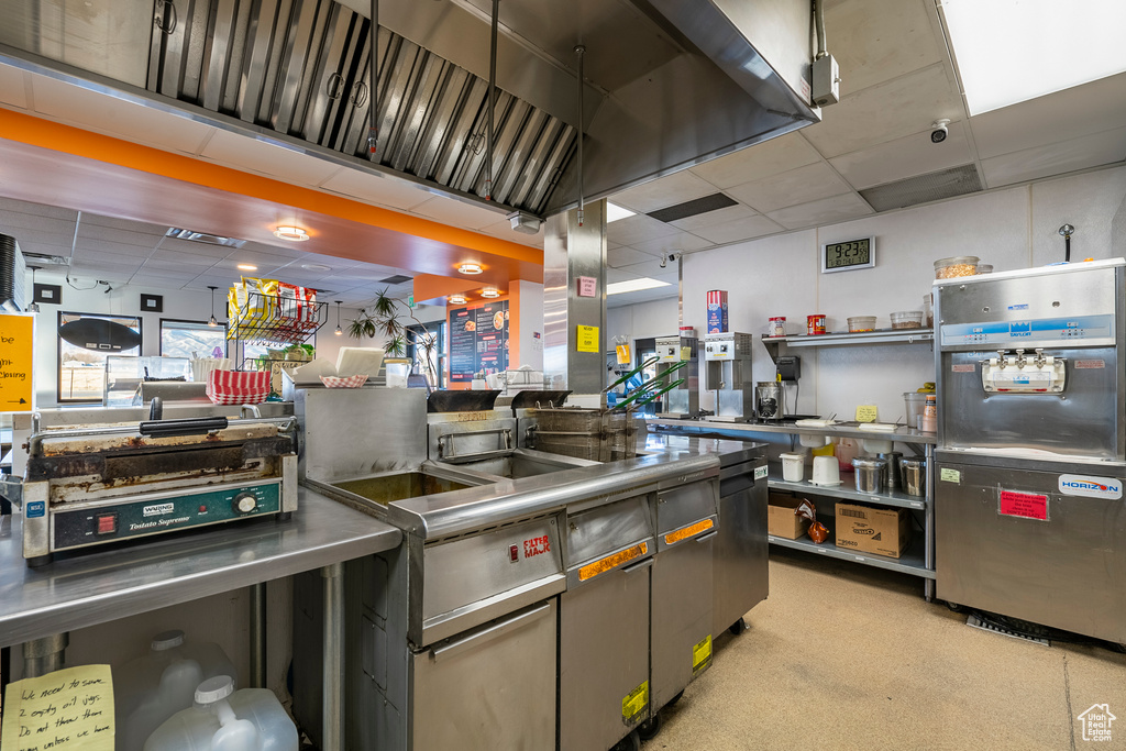 Kitchen with a drop ceiling and stainless steel counters
