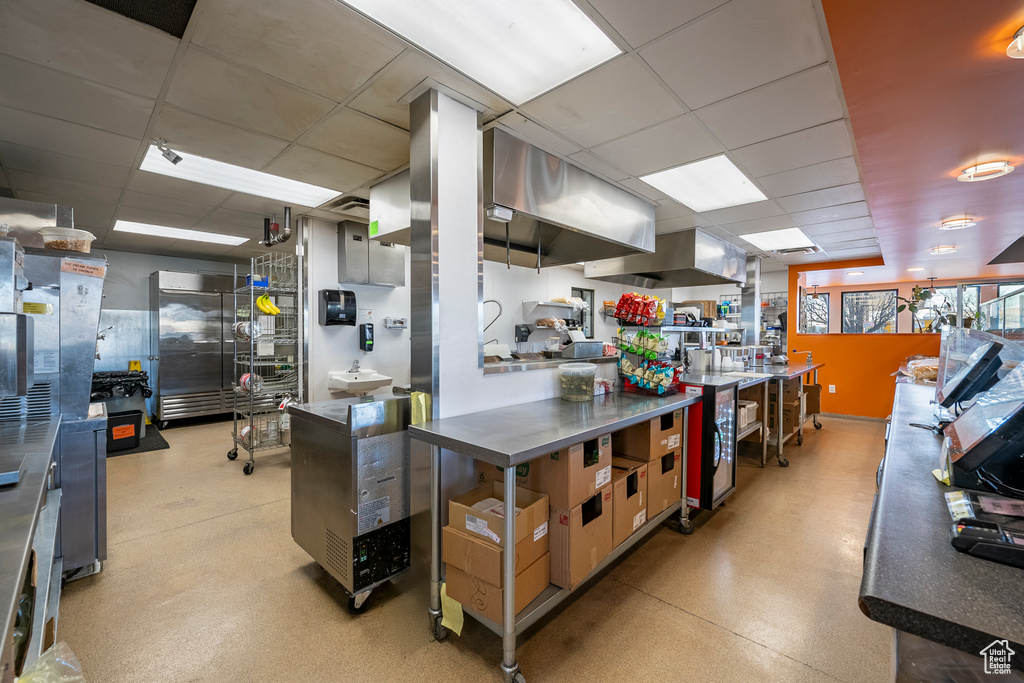 Kitchen featuring a drop ceiling and range hood