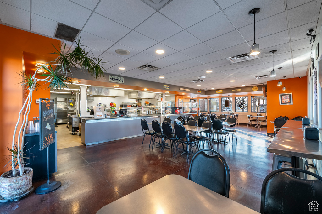 Dining room with concrete floors and a drop ceiling