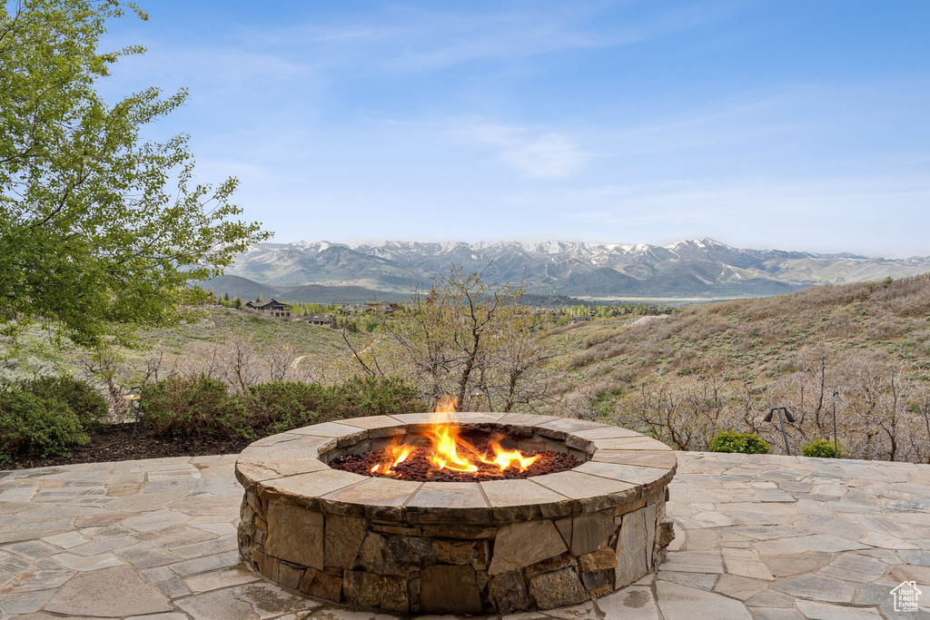 View of patio featuring an outdoor fire pit and a mountain view