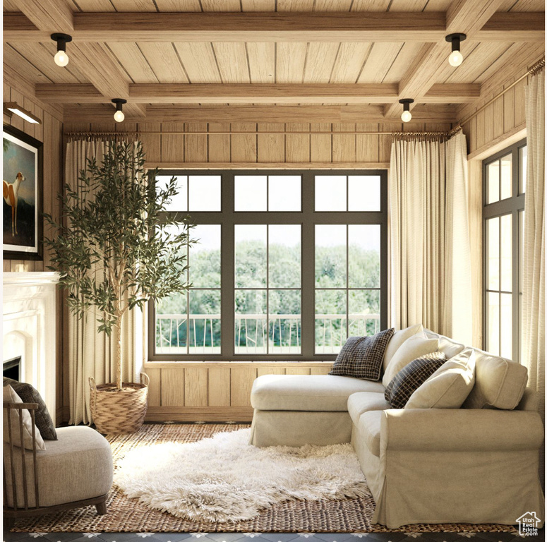 Sunroom featuring beamed ceiling, plenty of natural light, and wood ceiling