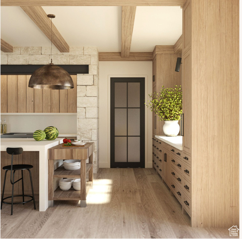 Interior space with beam ceiling and light hardwood / wood-style floors