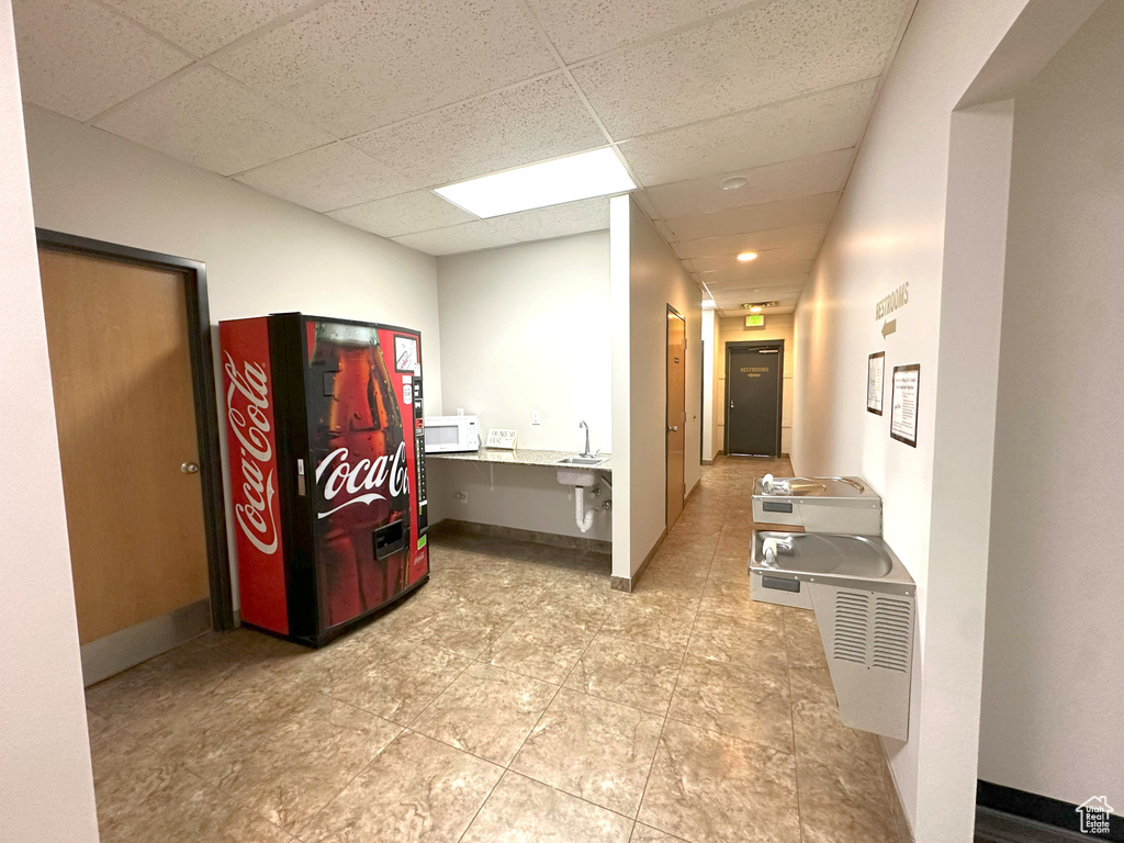 Hallway featuring sink and a paneled ceiling