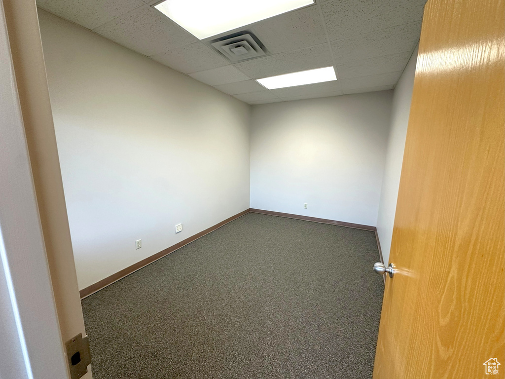 Carpeted spare room with a drop ceiling