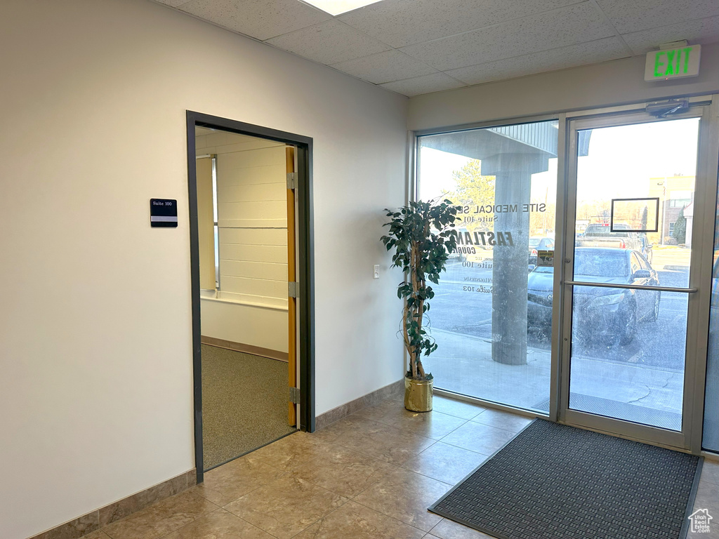Doorway to outside featuring a paneled ceiling