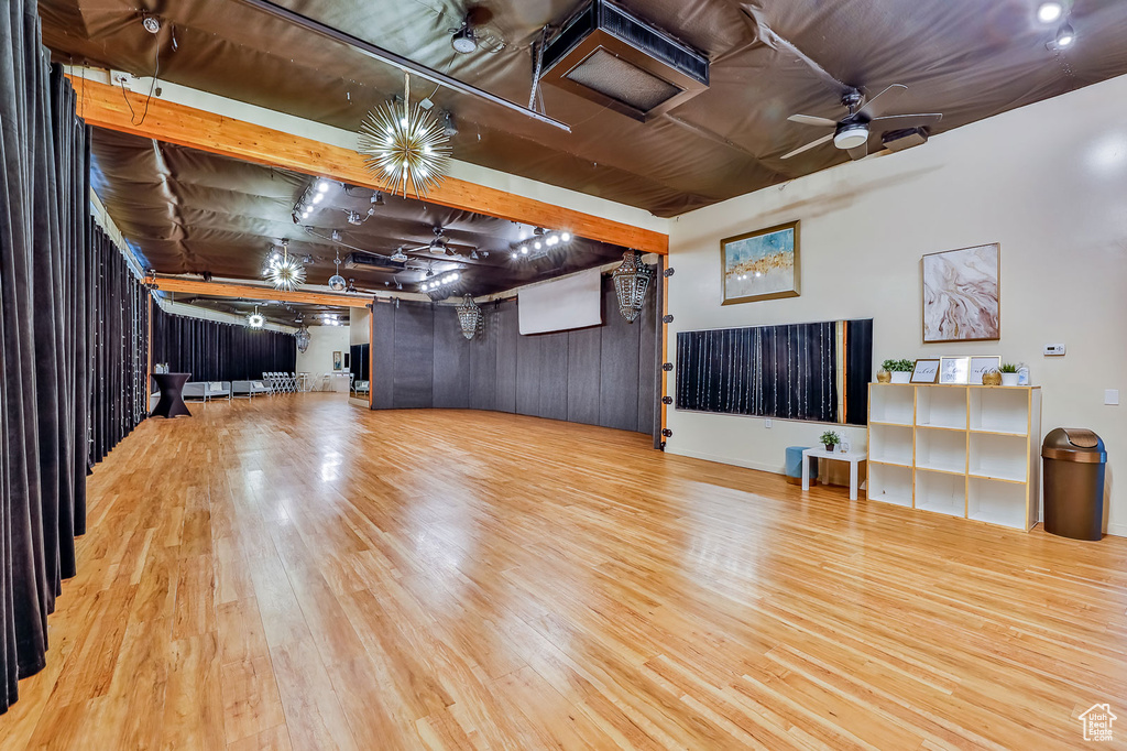 Unfurnished living room featuring a ceiling fan and wood finished floors