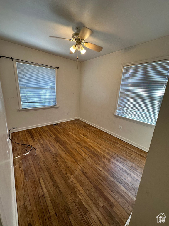 Unfurnished room with hardwood / wood-style flooring and ceiling fan