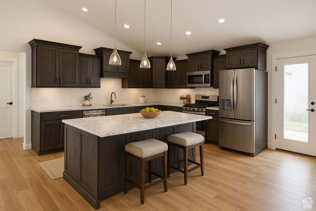 Kitchen featuring stainless steel appliances, dark brown cabinets, a sink, decorative backsplash, and recessed lighting