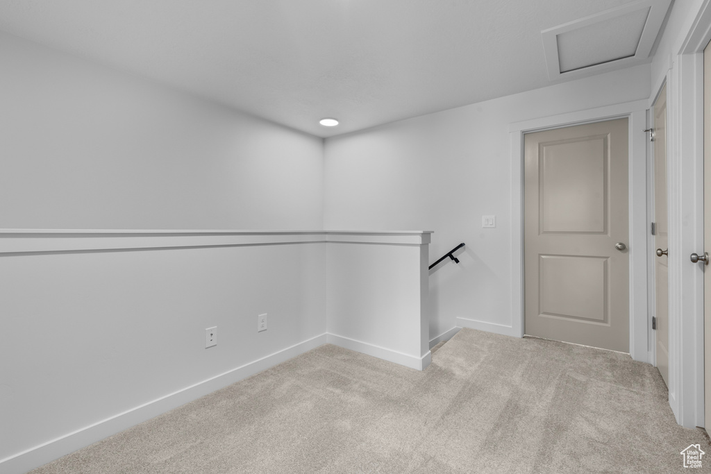 Unfurnished room featuring light carpet