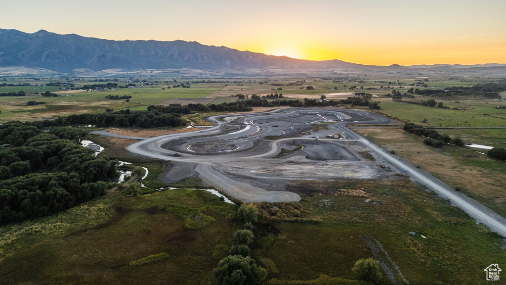 Aerial view at dusk featuring a mountain view and a rural view