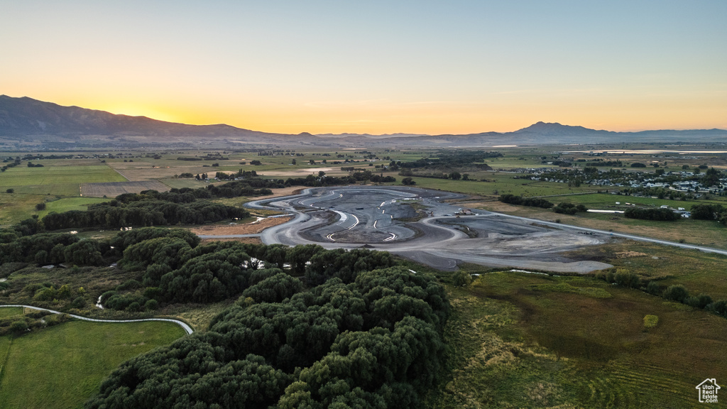 Aerial view at dusk featuring a rural view and a mountain view