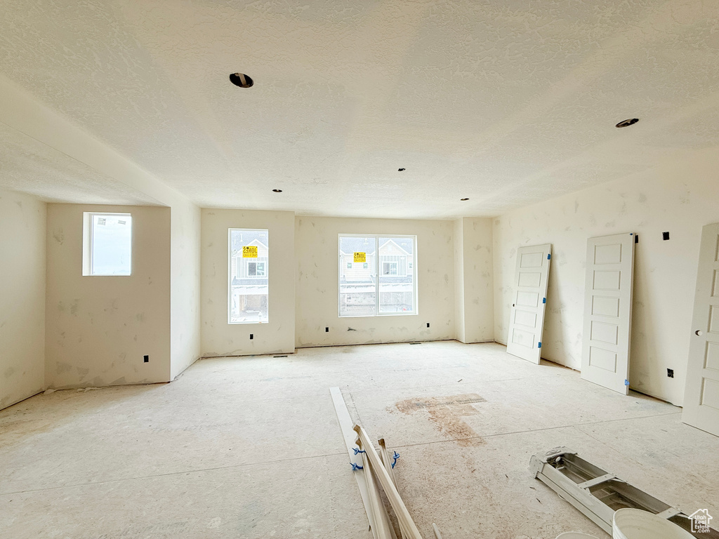 Unfurnished room featuring a textured ceiling