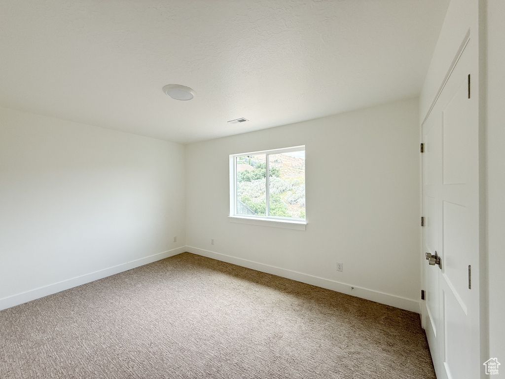 Spare room with carpet floors