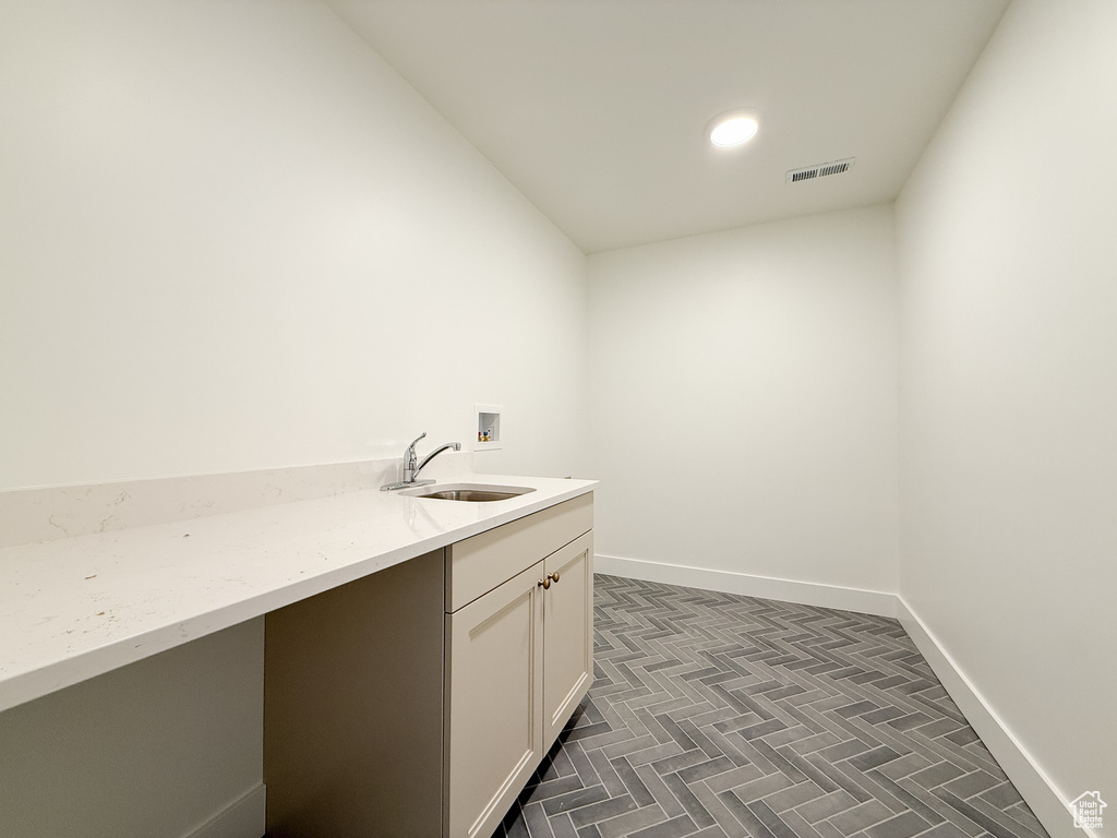 Laundry area with cabinet space, recessed lighting, and washer hookup