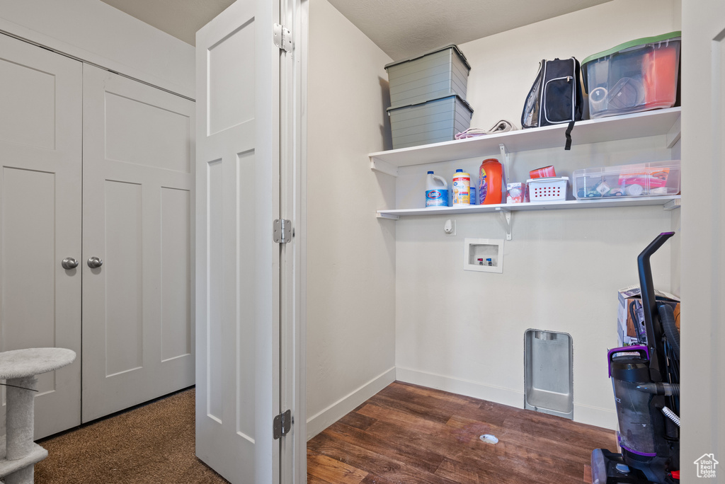 Laundry room with baseboards, wood finished floors, laundry area, and hookup for a washing machine