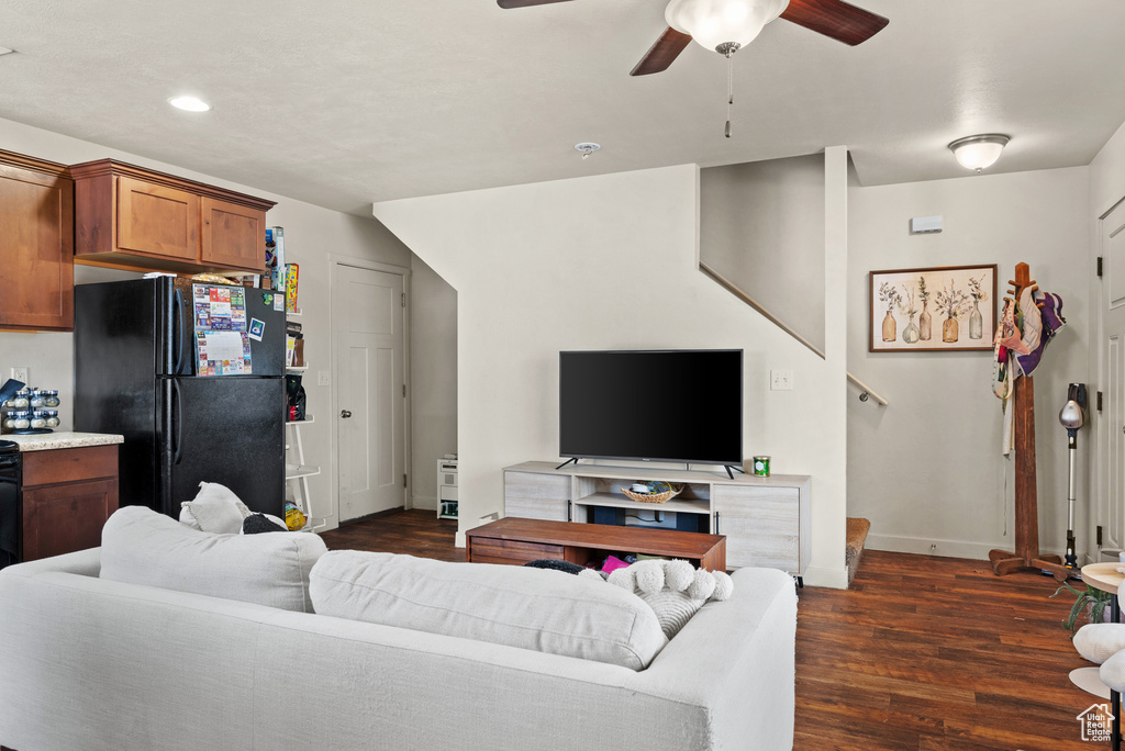 Living area with baseboards, recessed lighting, a ceiling fan, and dark wood finished floors