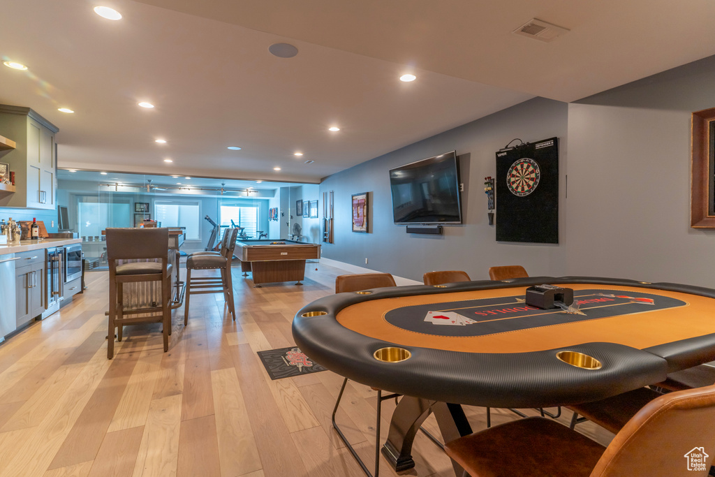 Dining space featuring indoor bar and light hardwood / wood-style flooring