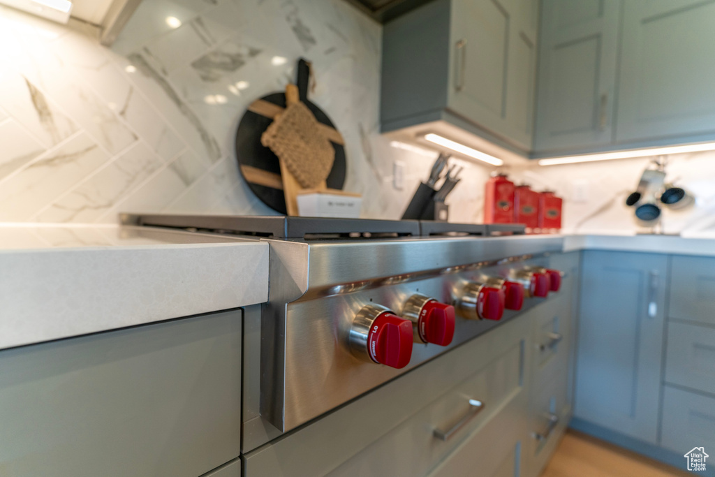Kitchen with stainless steel gas cooktop