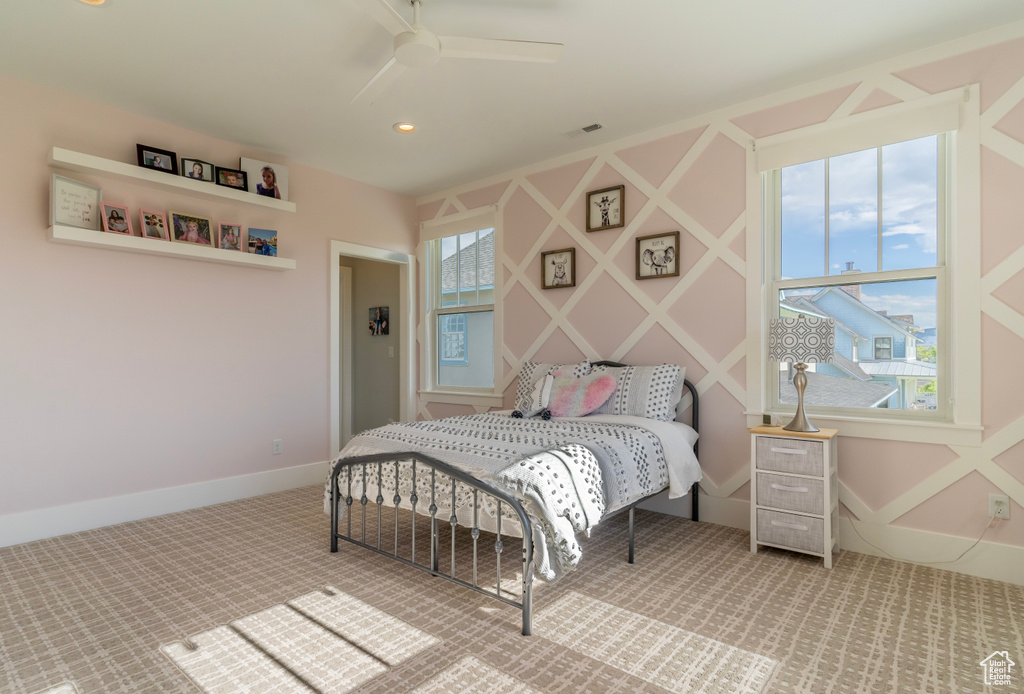 Carpeted bedroom with ceiling fan