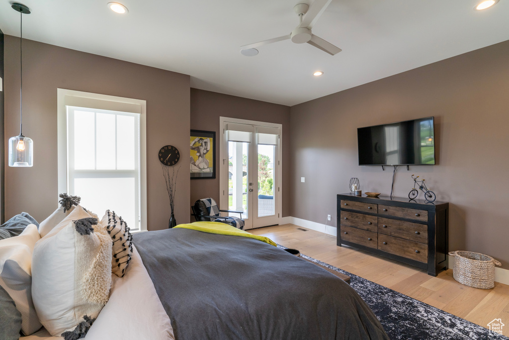 Bedroom featuring ceiling fan, access to outside, light hardwood / wood-style floors, and french doors