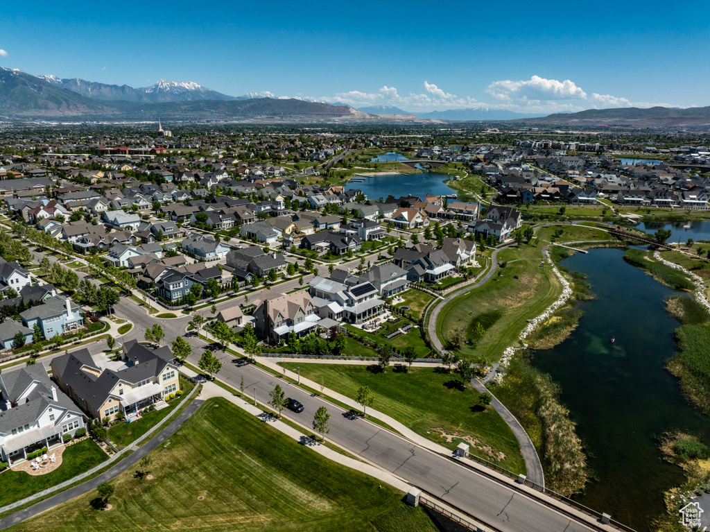 Birds eye view of property with a water and mountain view