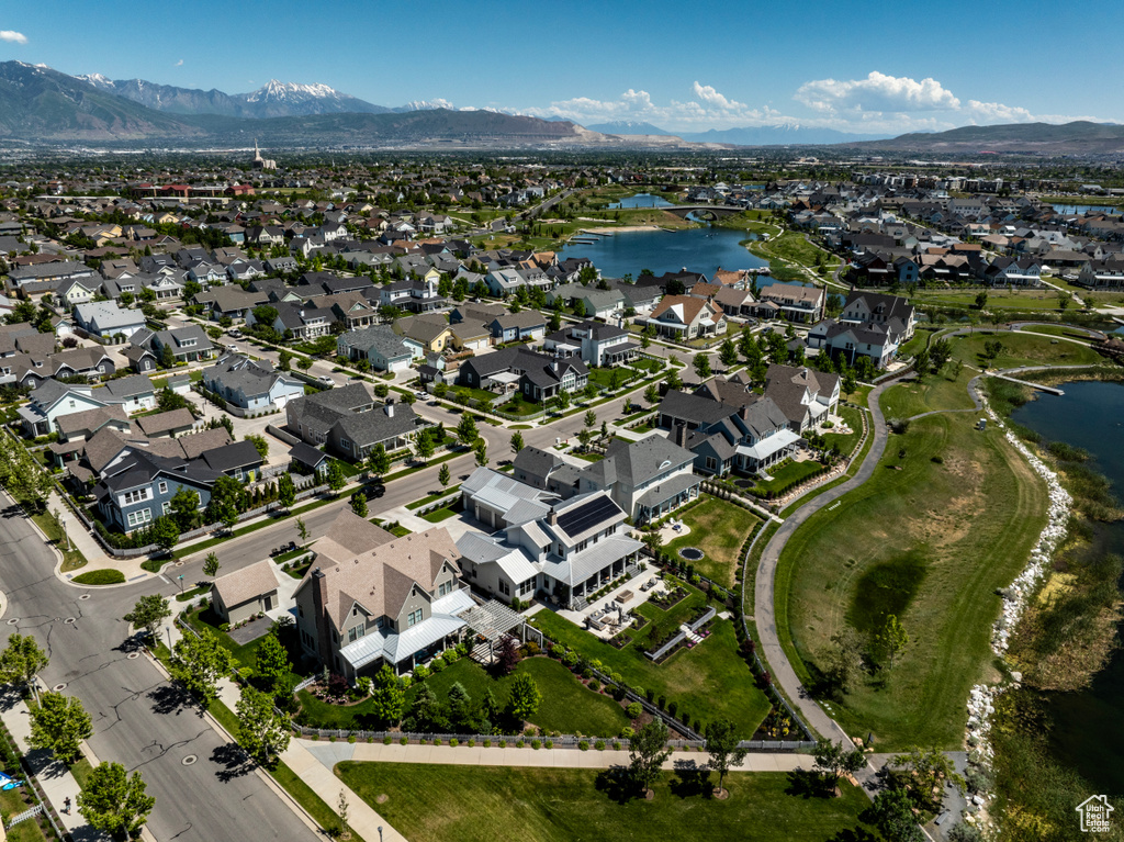 Birds eye view of property with a water and mountain view