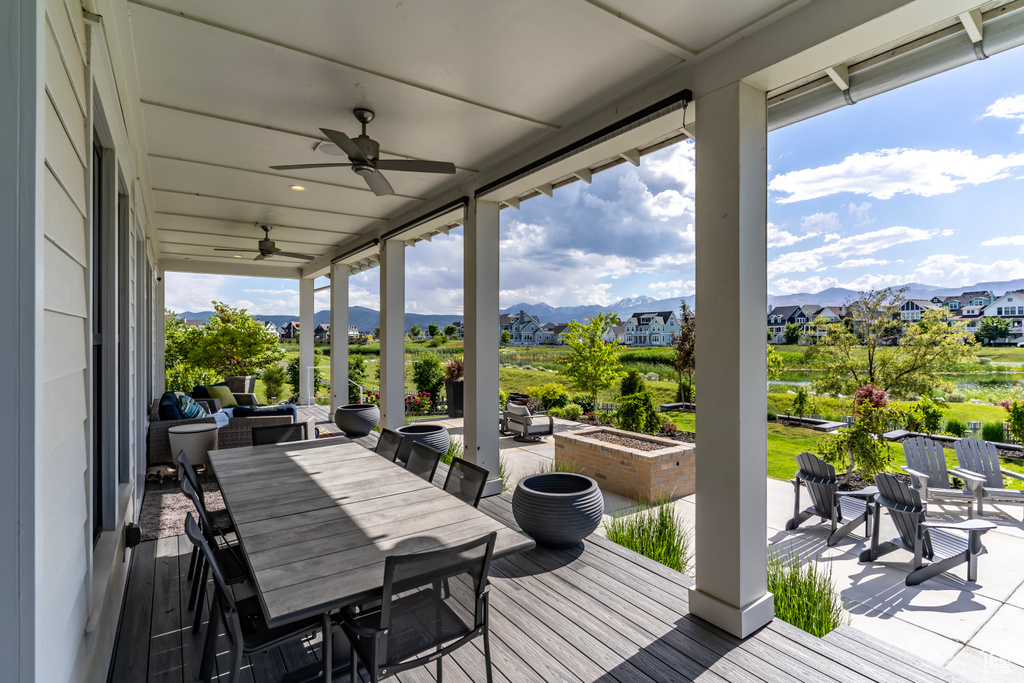 Wooden deck with a patio, a mountain view, and ceiling fan