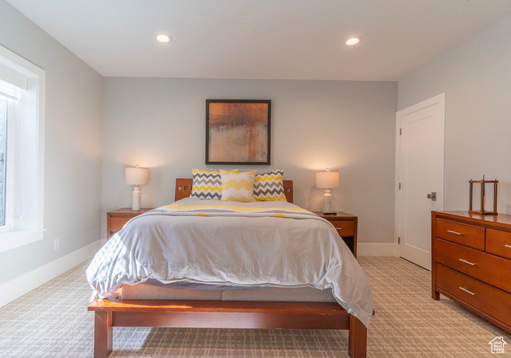 Bedroom featuring light colored carpet