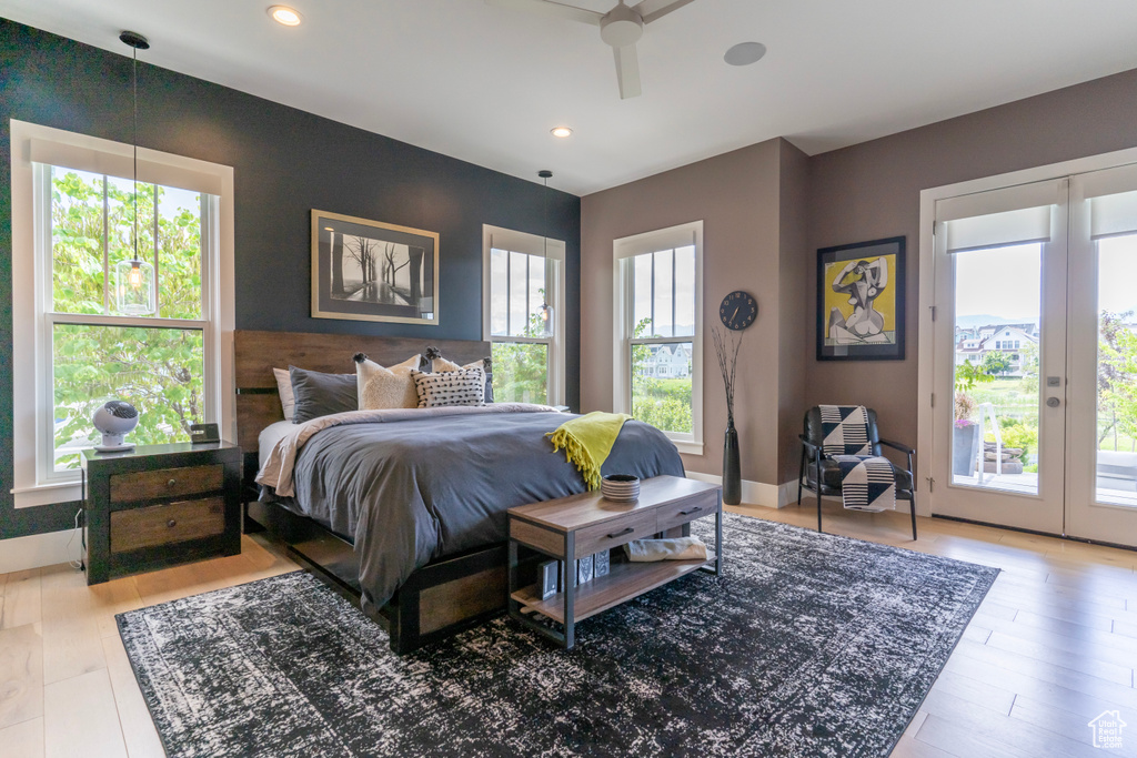 Bedroom featuring hardwood / wood-style flooring, access to exterior, and french doors