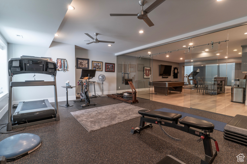Exercise room with ceiling fan and track lighting