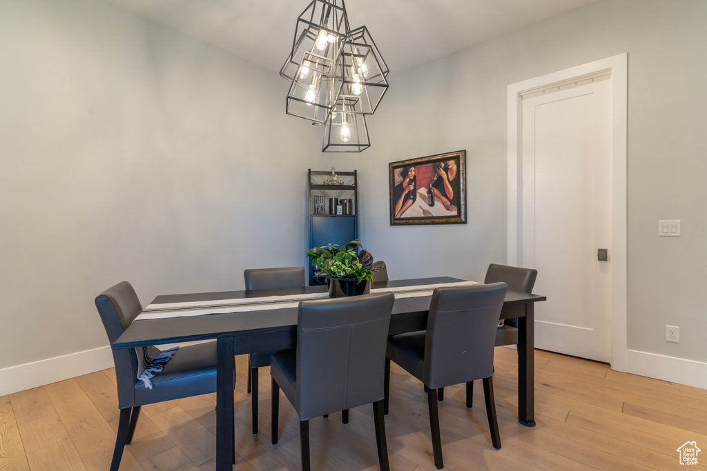 Dining room with a chandelier and light wood-type flooring
