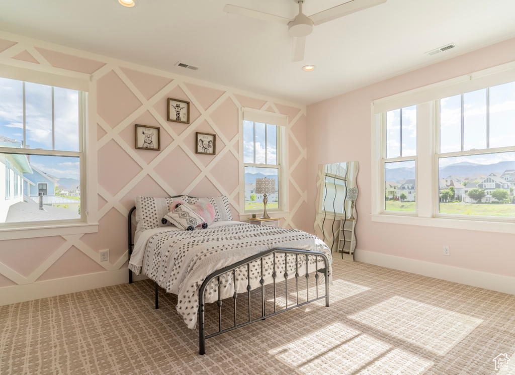 Bedroom with ceiling fan and carpet